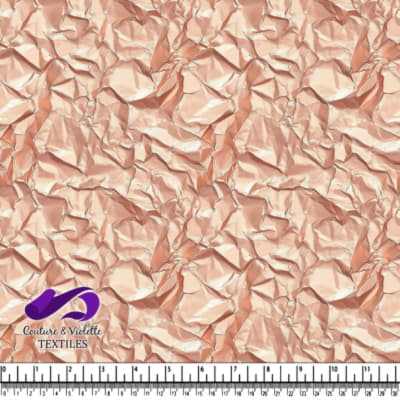 Crumpled shiny metallic rose gold fabric texture